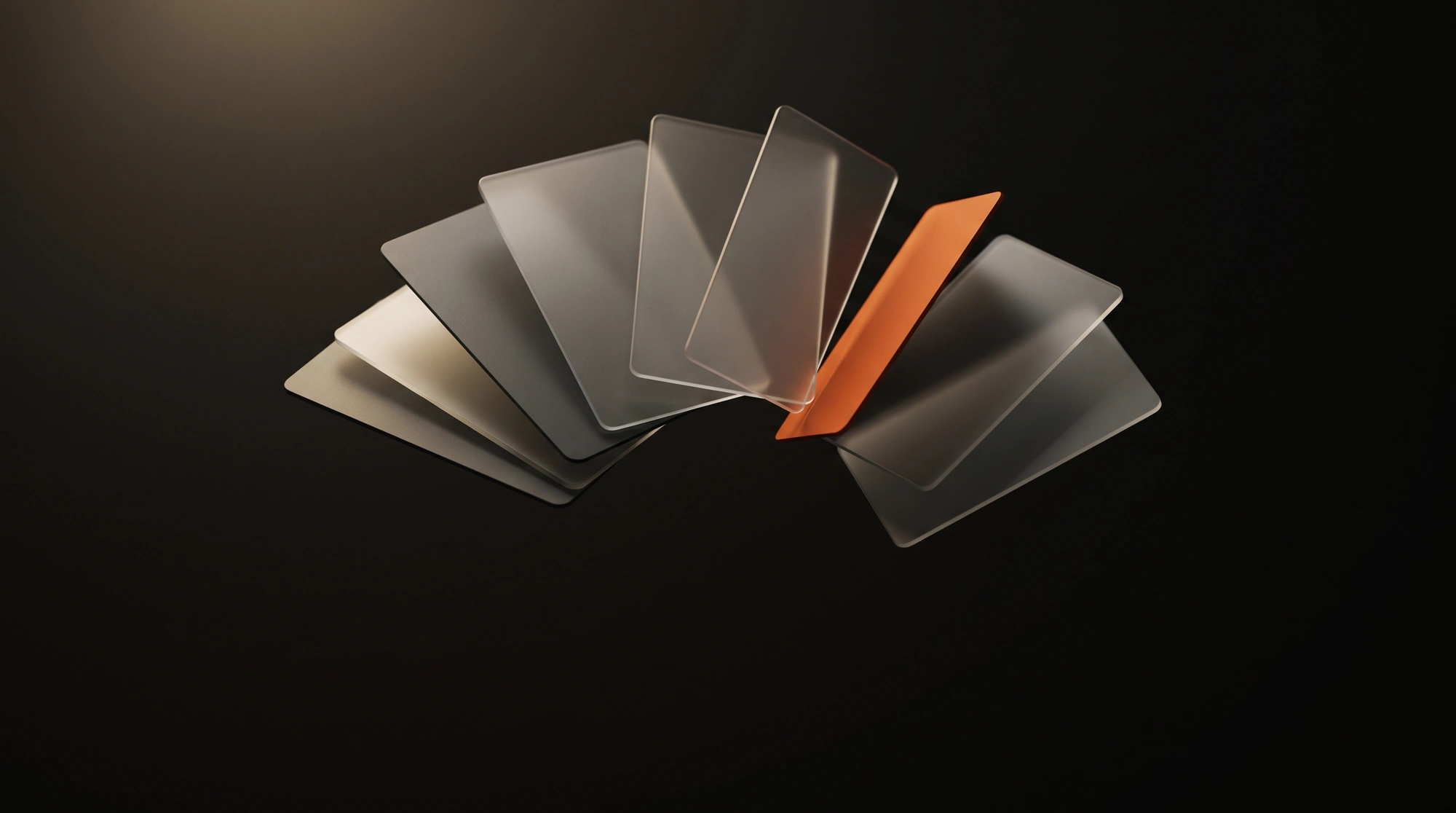 An abstract fan of thin frosted glass cards, one accented in ember.